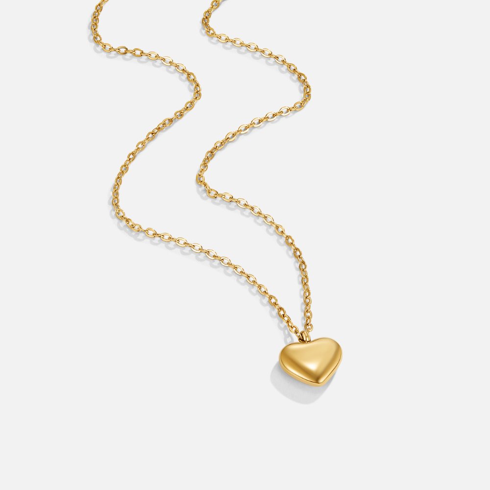 Marina Love Gold Necklace, laid flat on white, gold chain with a puffed heart pendant