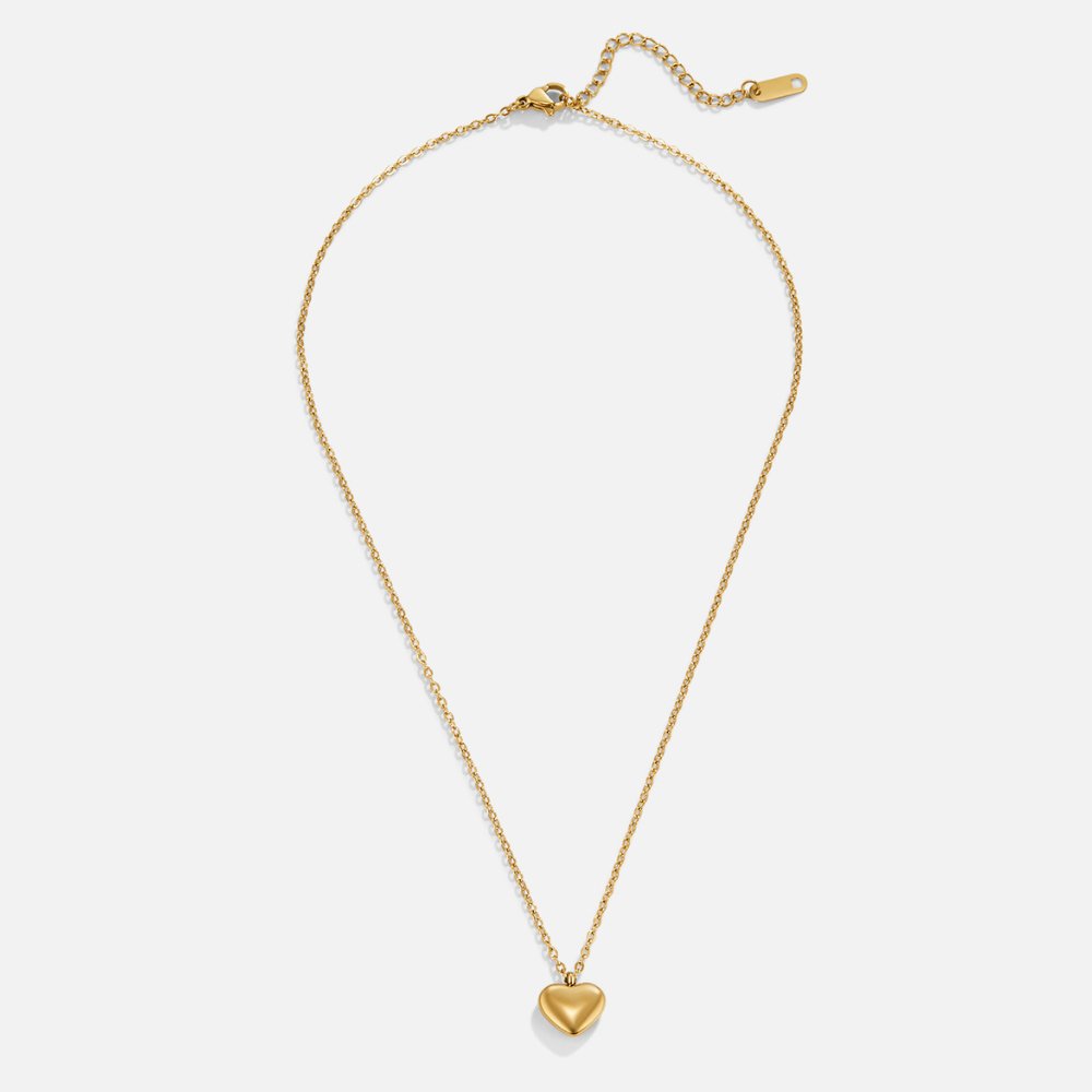 Marina Love Gold Necklace, flat lay of a gold chain necklace with a puffed heart pendant