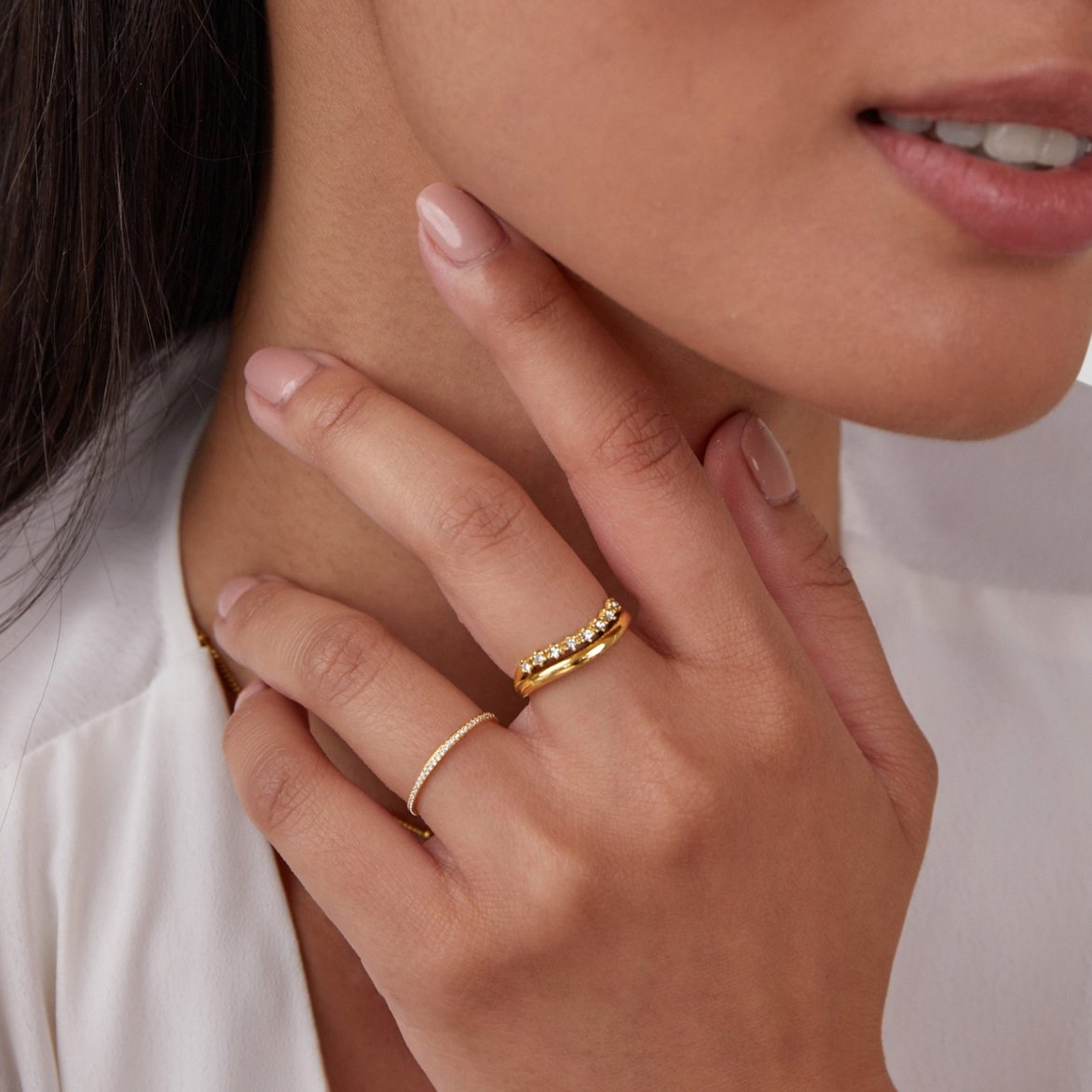 Marissa White Crystal Layered Ring, worn on a hand touching the chin, with a thin pave band