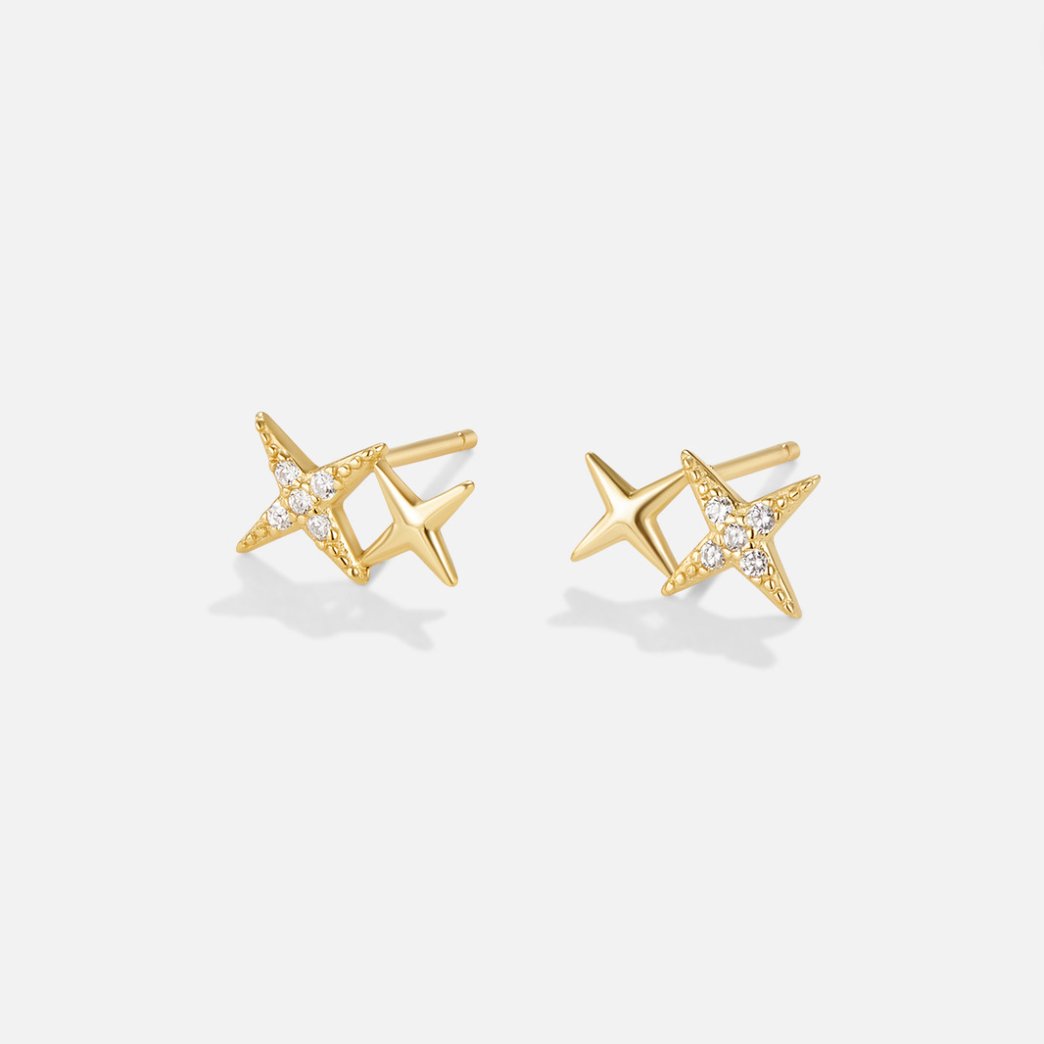 Midnight Magic Studs, pair of gold star studs, one with small white stones