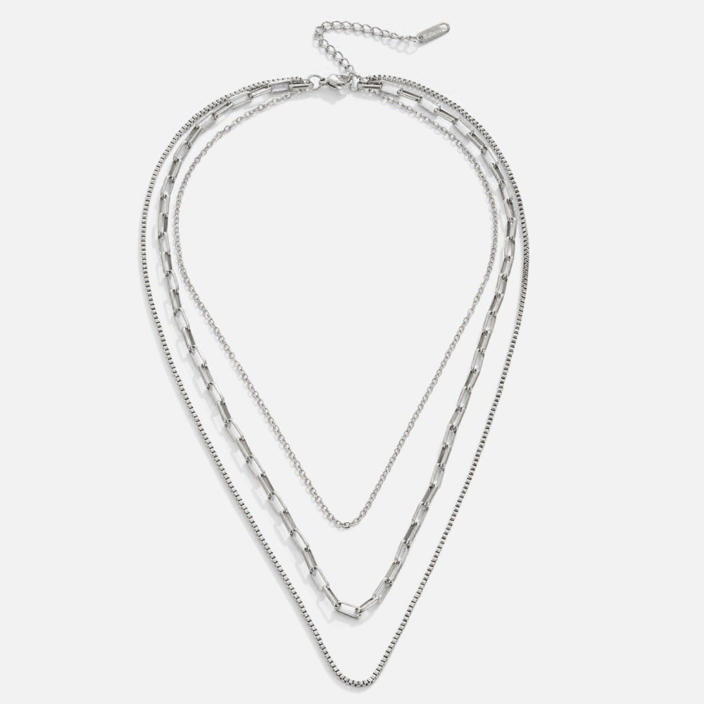 Miela Layered Chain Necklace, three silver chains layered in a V-shape on a plain background
