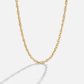 Mila Twist Gold Chain Necklace, gold twisted chain lying in a curve on a pale background