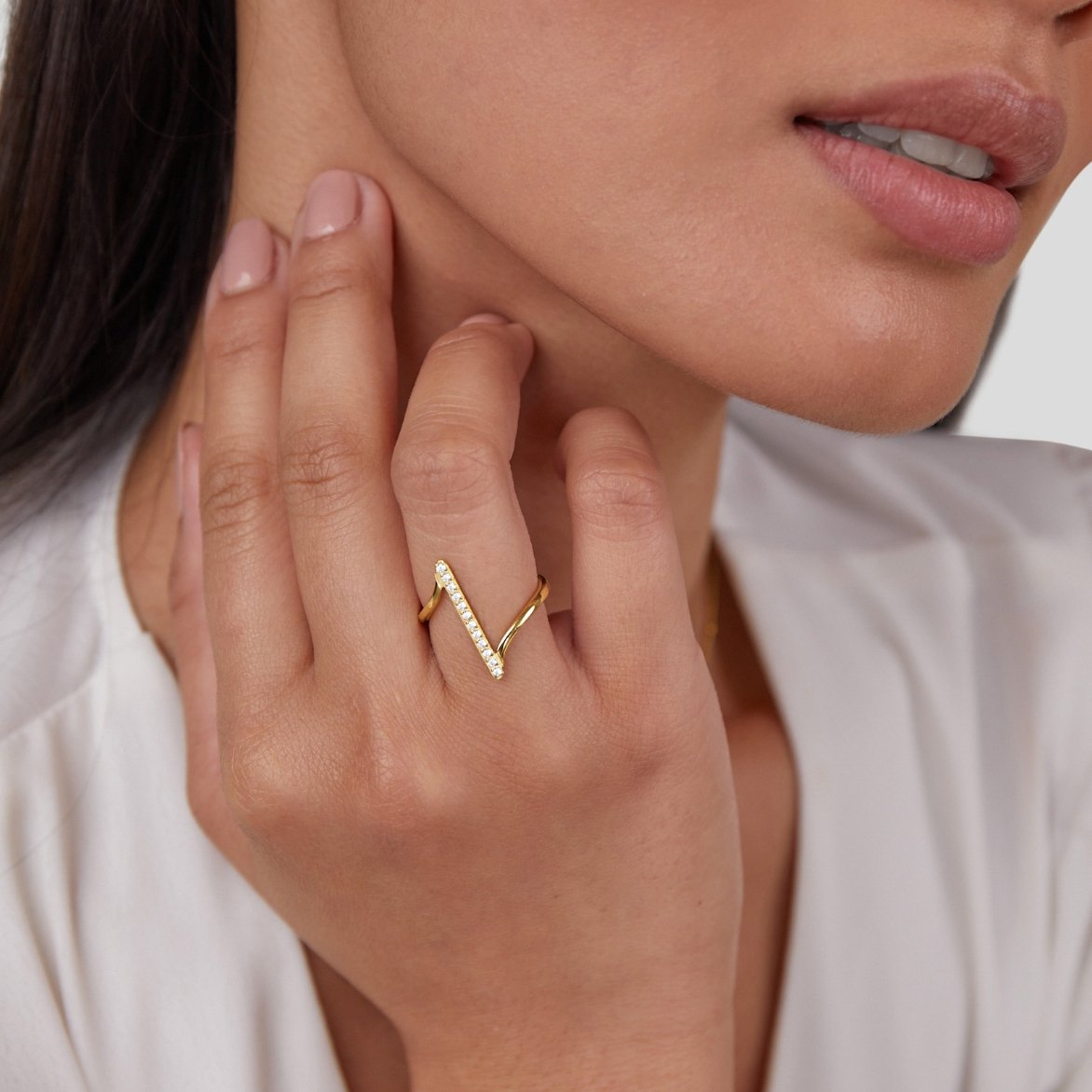 Mila Twisted Gold Ring, worn on a hand near the neck, zigzag band with small stones