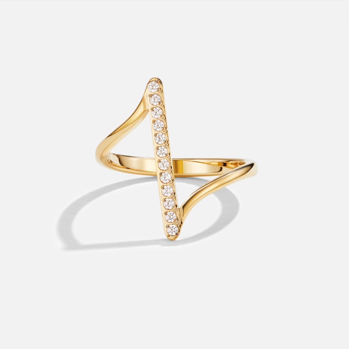 Mila Twisted Gold Ring, standing ring on white background, gold with a row of clear stones