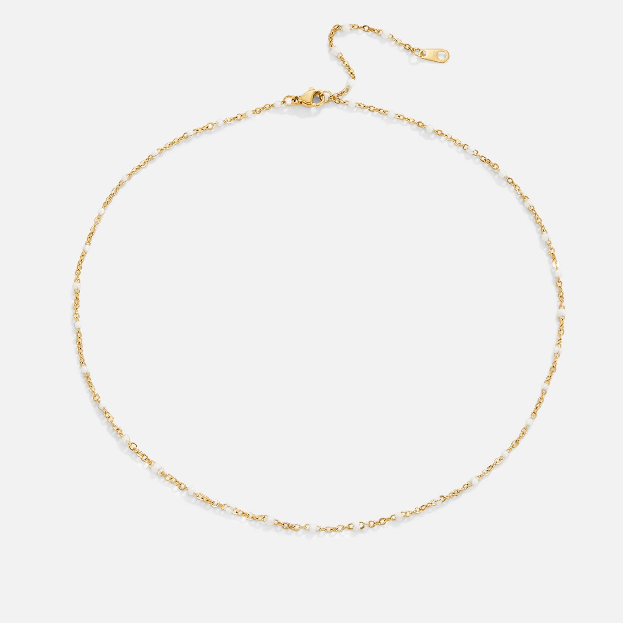 Mila White Bead Necklace, flat lay of a gold chain necklace with small white beads and a lobster clasp