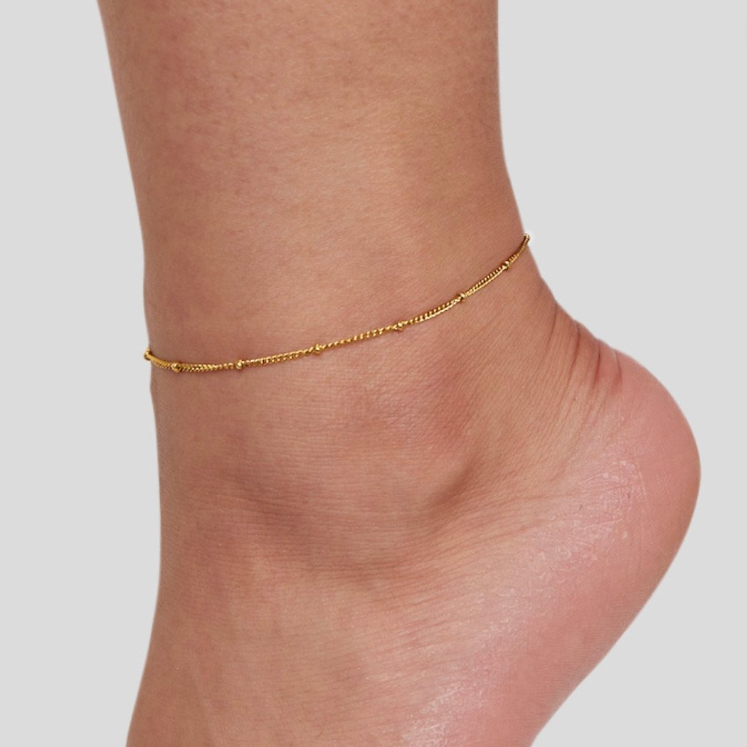 Mira Beaded Gold Anklet, worn on an ankle, fine gold chain with small beads