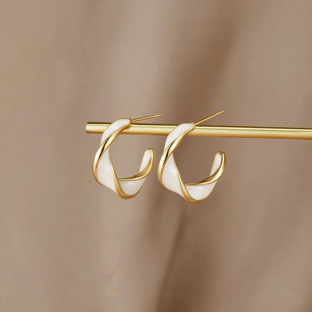 Mother of Pearl Twist Hoop Earrings, two gold twisted hoops with white enamel, hung on a gold bar