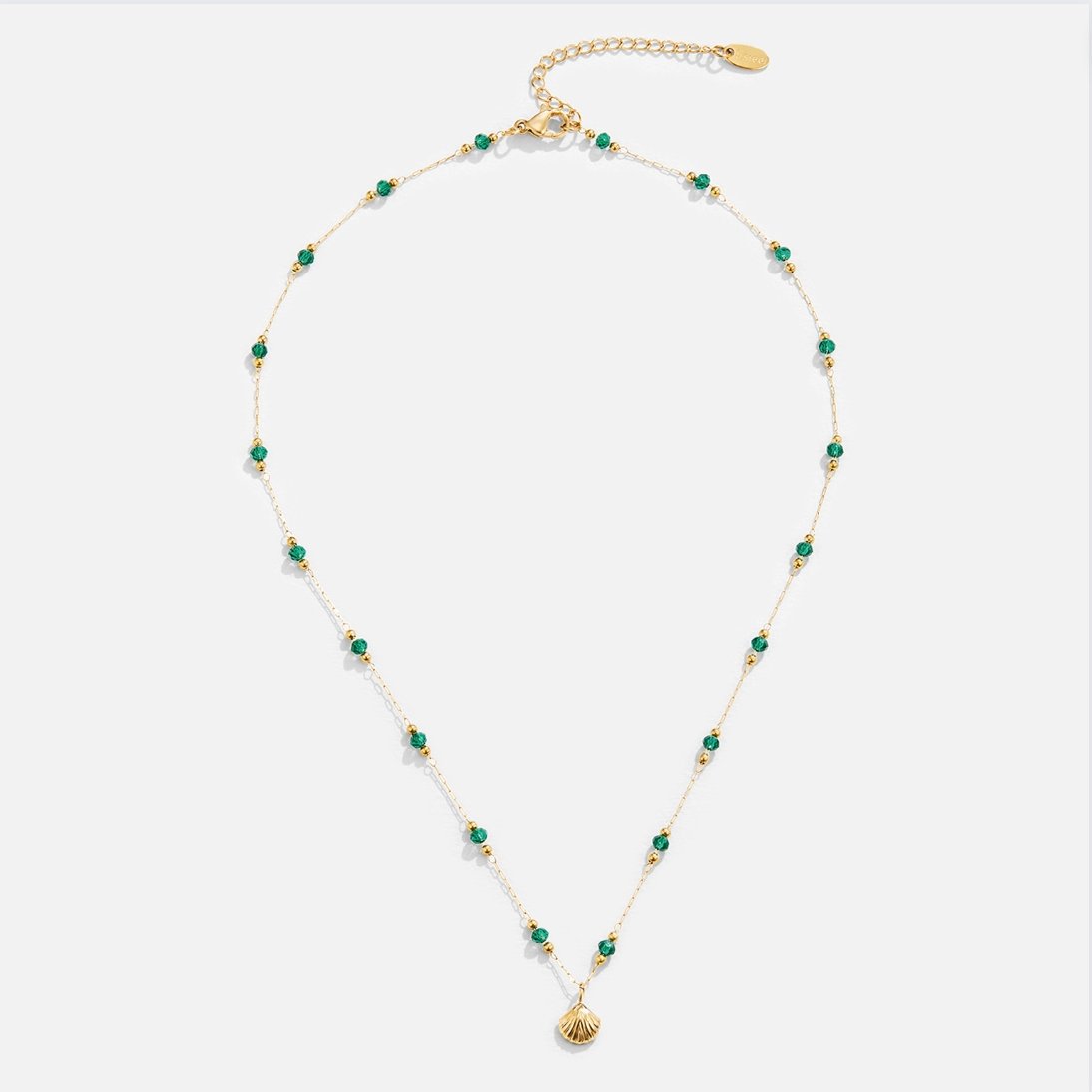 Nerissa Gold Shell & Green Bead Necklace, flat lay of gold chain with green beads and shell pendant