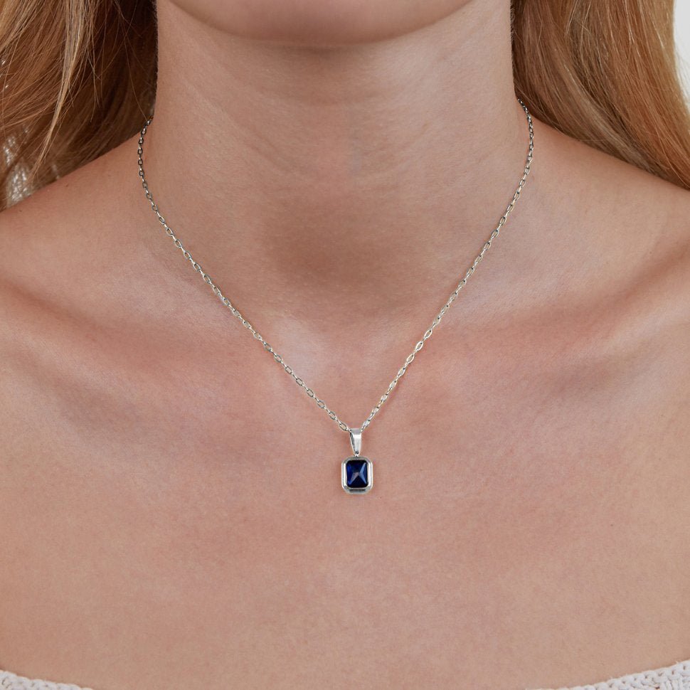 Ocean Blue Pendant Silver Necklace, worn on a neck with a silver chain and blue stone