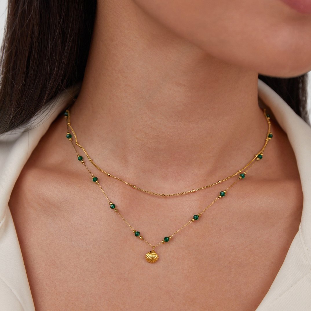 Ocean Lover Shell & Bead Necklace Set, worn layered on a neck, with a gold shell pendant and