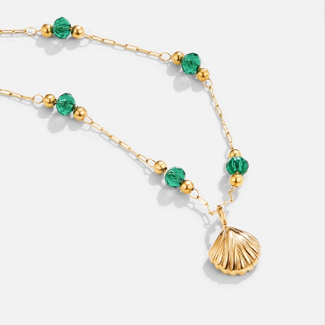 Ocean Lover Shell & Bead Necklace Set, gold chain with green beads and a gold shell pendant on white