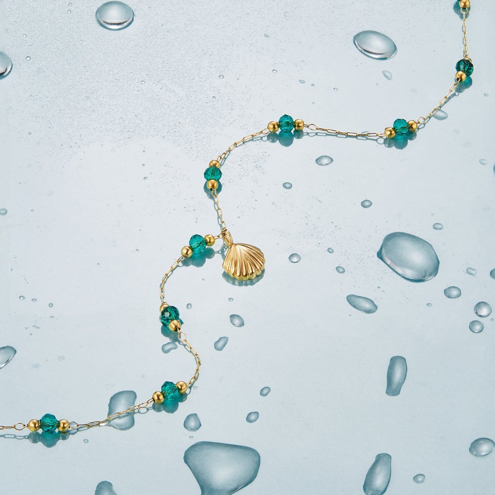 Ocean Lover Shell & Bead Necklace Set, gold chain with green beads and a shell pendant, laid