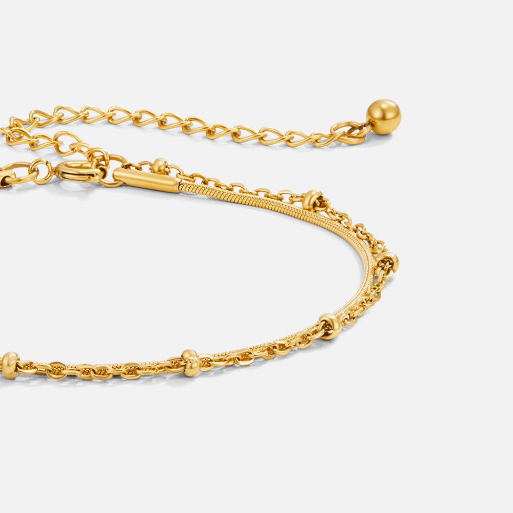 Pia Gold Layered Bracelet, layered gold chain bracelet laid flat on white, close-up of clasp
