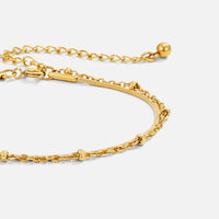 Pia Gold Layered Bracelet, layered gold chain bracelet laid flat on white, close-up of clasp