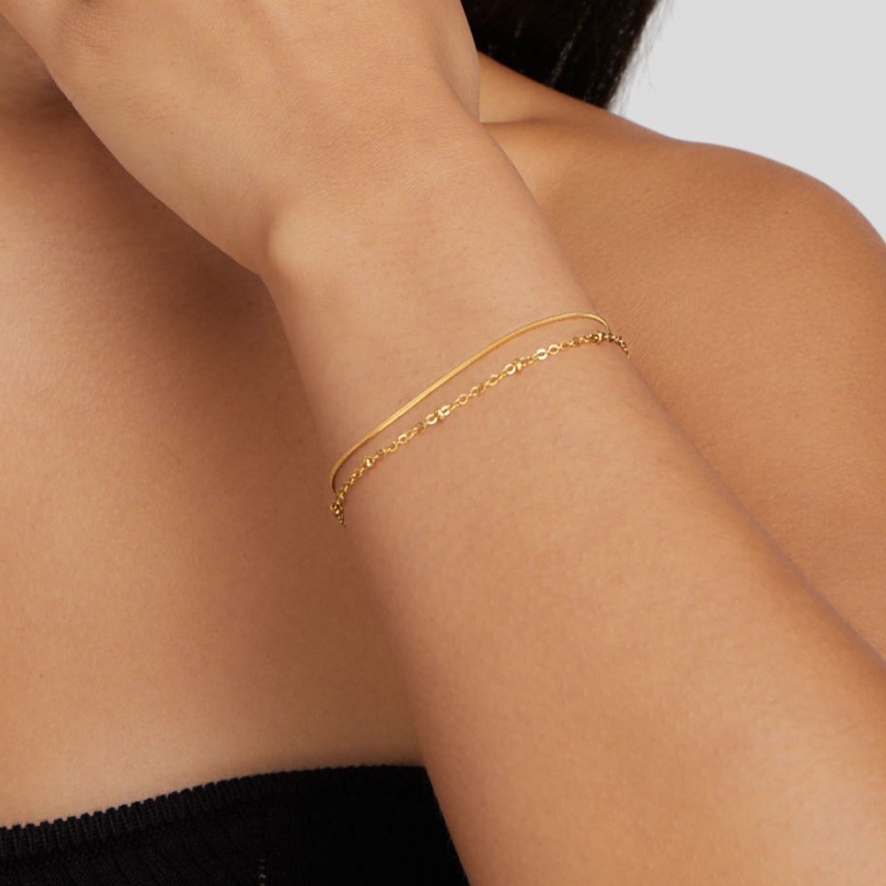 Pia Gold Layered Bracelet, worn on a wrist, layered with a fine gold chain