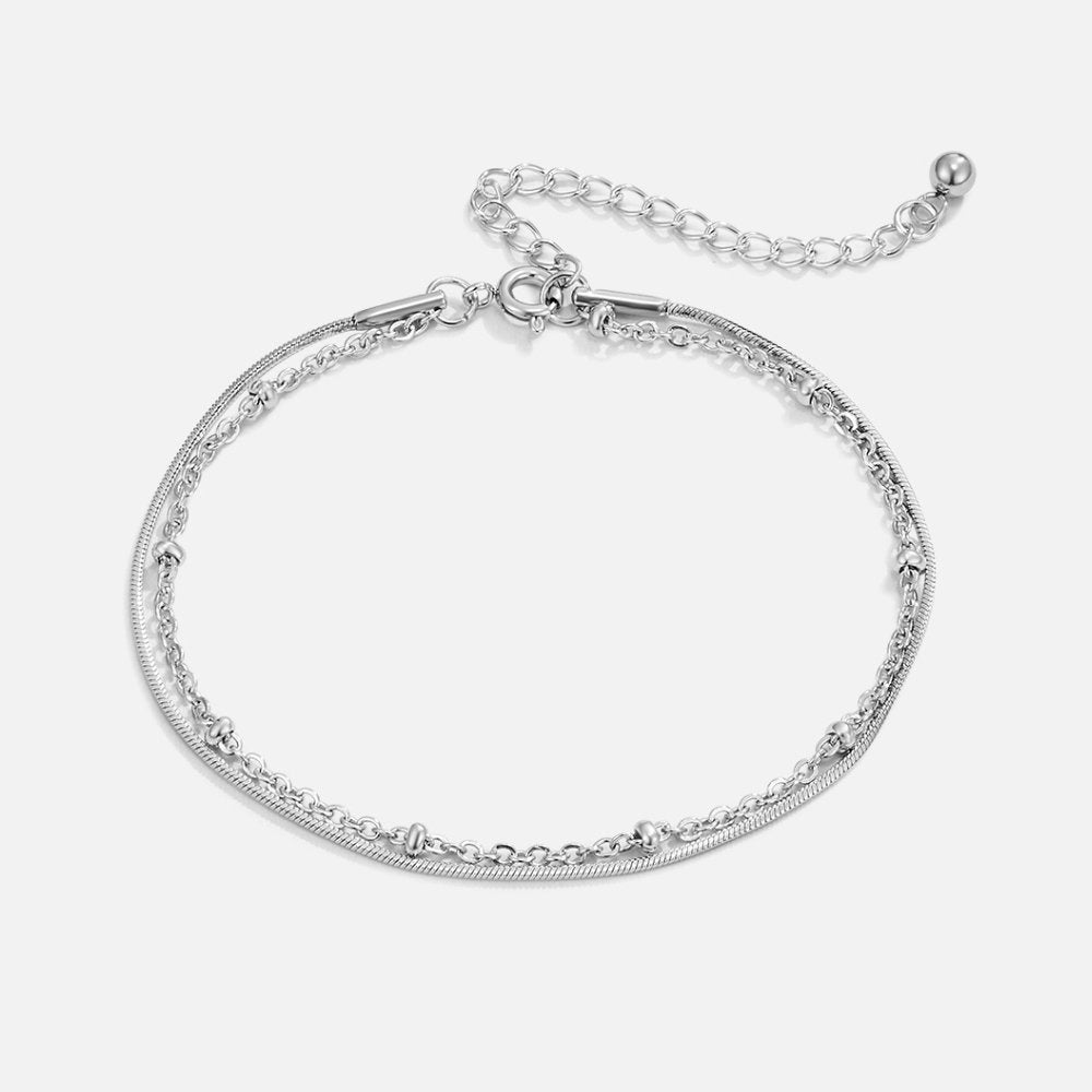 Pia Silver Layered Bracelet, laid flat on white, two silver chains with bead accents