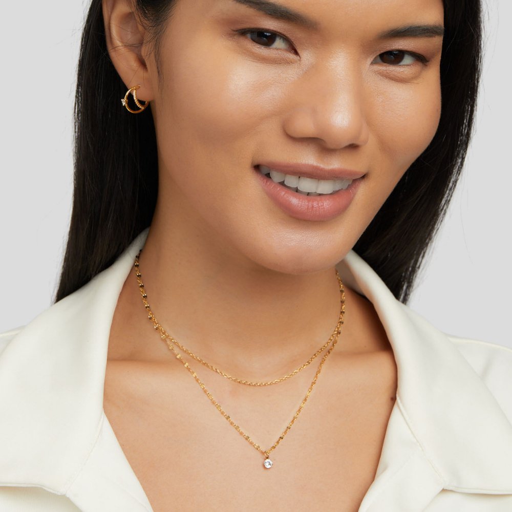 Piya Crystal Layered Necklace, worn on a smiling model in a white collared top
