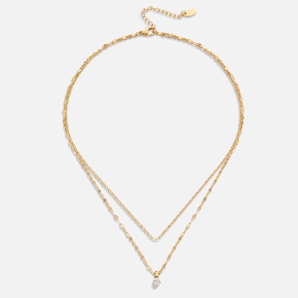 Piya Crystal Layered Necklace, flat lay of two gold chains, one with a small clear stone