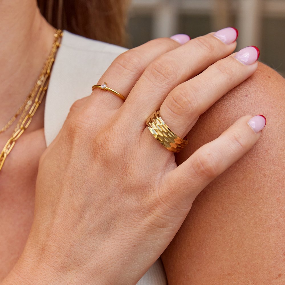 Rene Chunky Gold Ring, worn on a hand resting on a shoulder, with a textured gold band