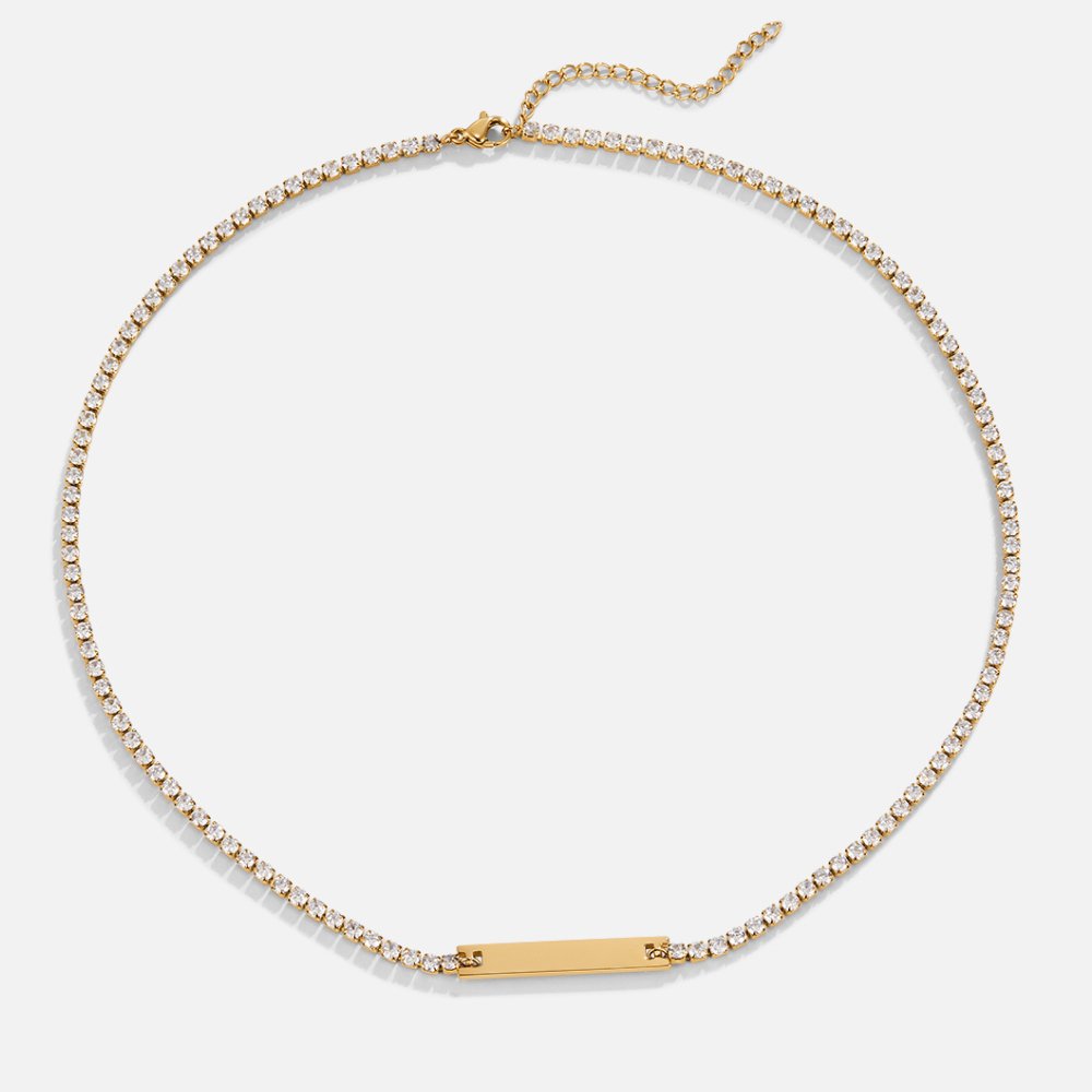 Rina Crystal Necklace, laid flat on white, gold crystal tennis chain with bar pendant