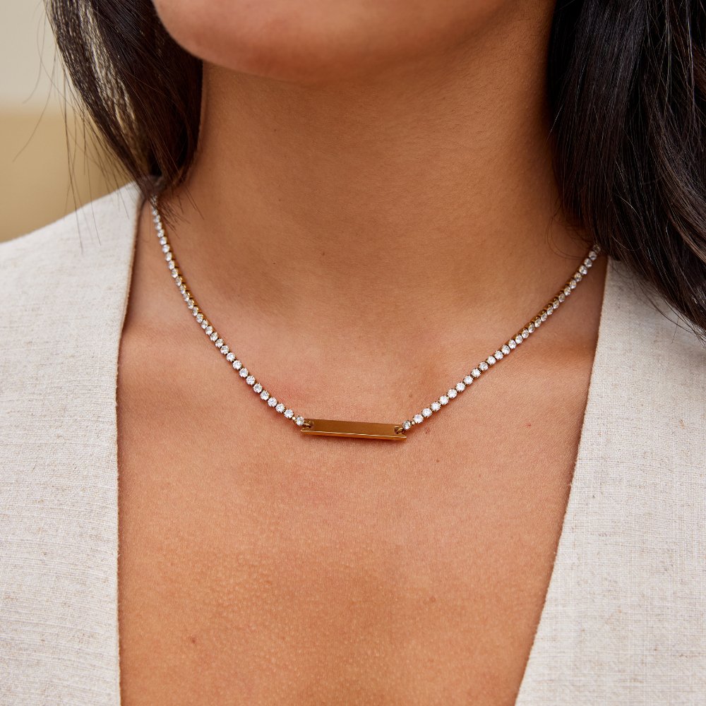 Rina Crystal Necklace, worn at the neckline with a polished gold bar and crystal chain