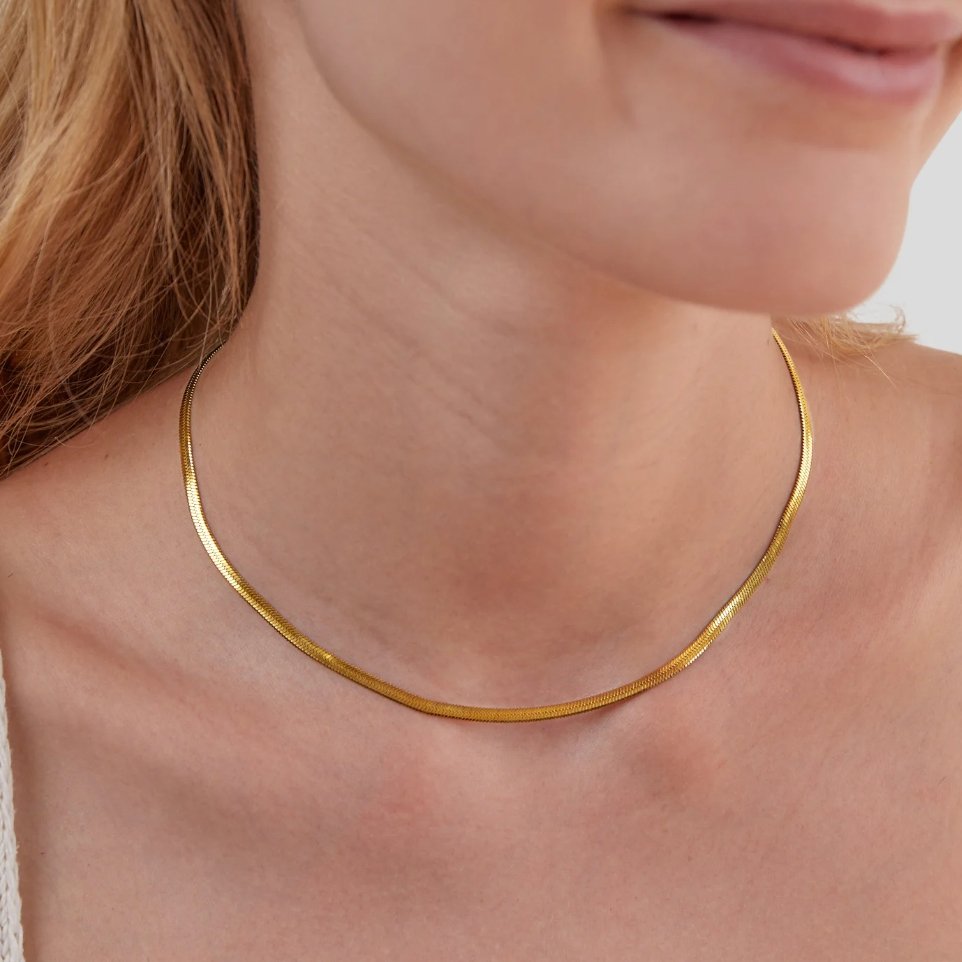 Sarya Snake Chain Gold Necklace, worn on a neck, close-up of a flat gold chain