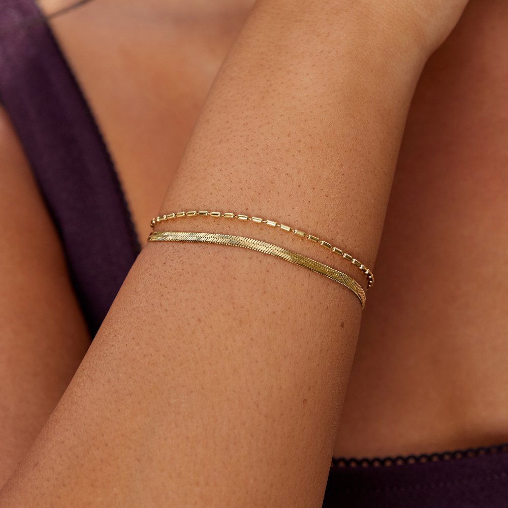 Selene Snake & Bead Chain Bracelet, worn stacked on a wrist, two thin gold chains