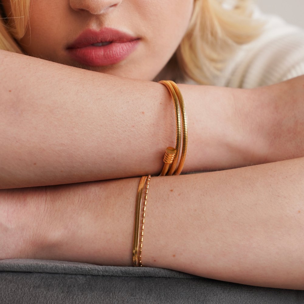 Selene Snake & Bead Chain Bracelet, worn on a wrist with a gold bangle and chain layered
