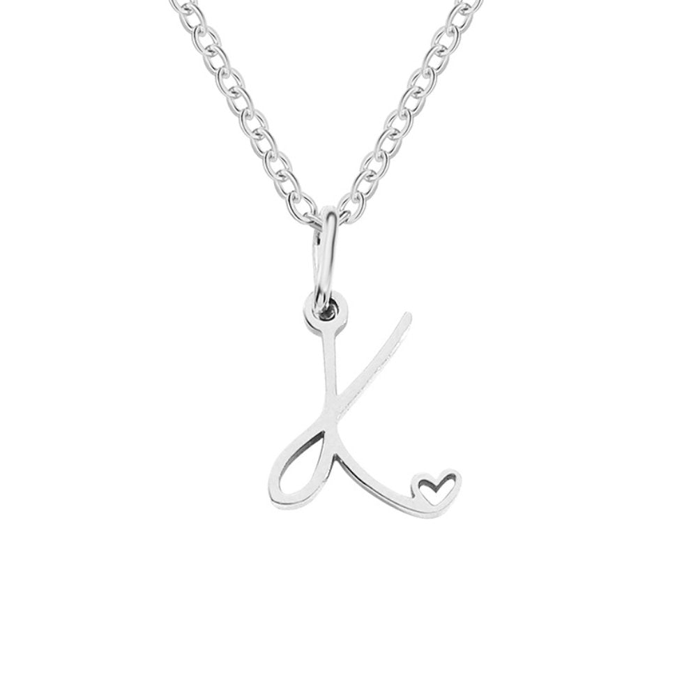Silver Letter Heart Necklace, hanging on a plain background, silver script letter K with heart