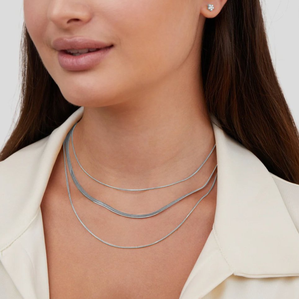 Silver Multi-Layered Chain Necklace, worn layered at the neck over a cream collared top