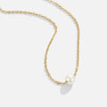 Solitaire Gold Pearl Necklace, gold chain necklace laid on white with a single white pearl