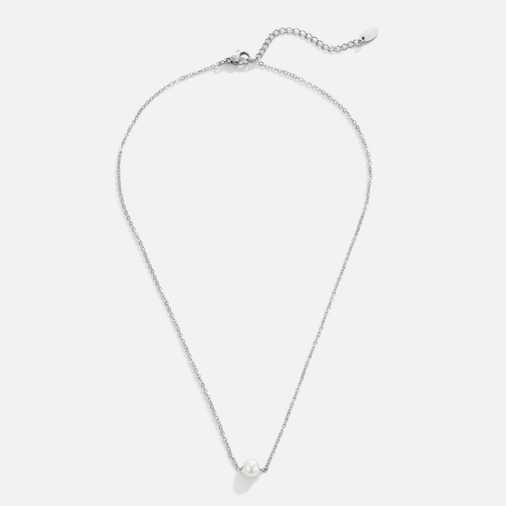 Solitaire Silver Pearl Necklace, flat lay of a silver chain with one white pearl at the centre