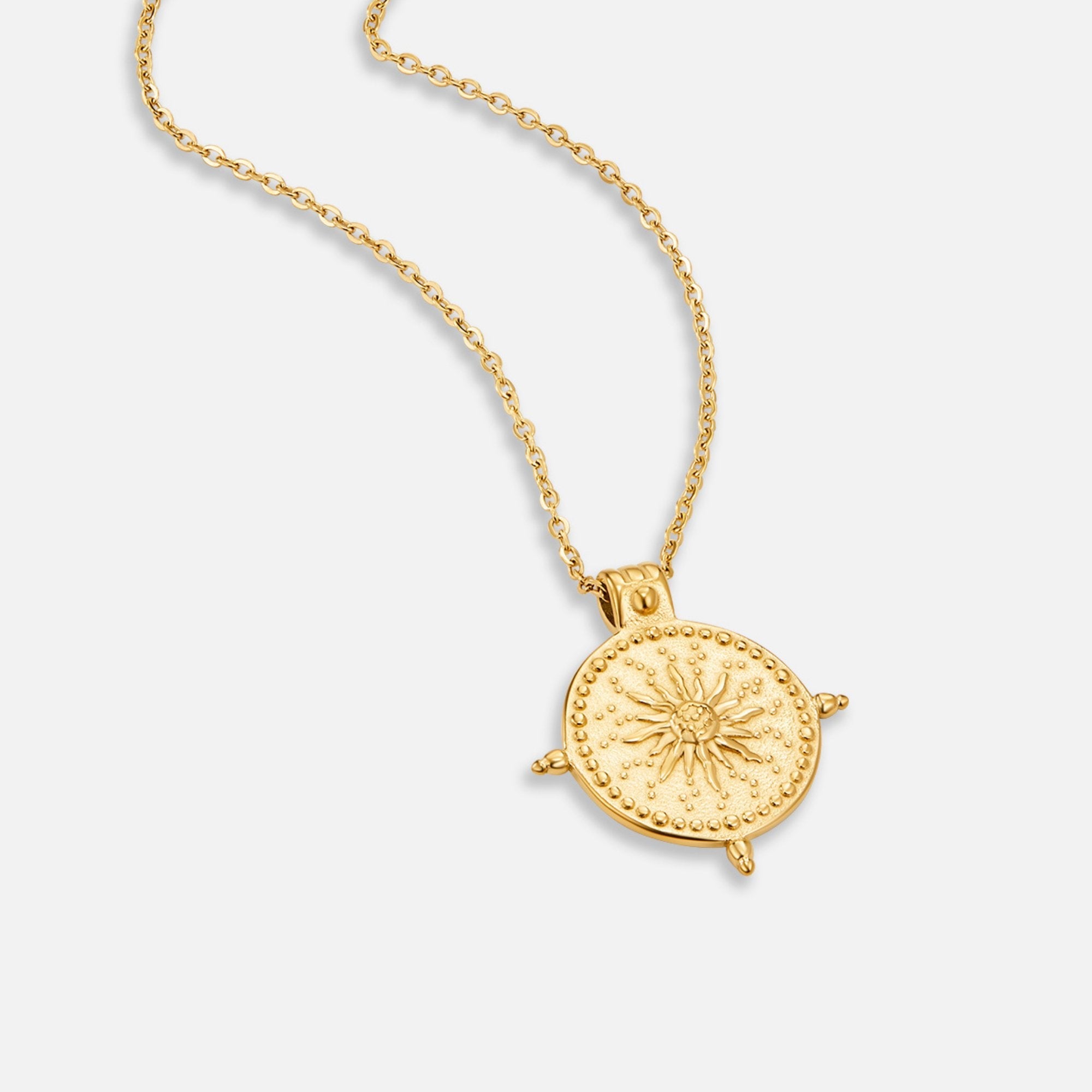 Summer Solstice Gold Necklace, gold necklace lying flat on white, round pendant with sun motif