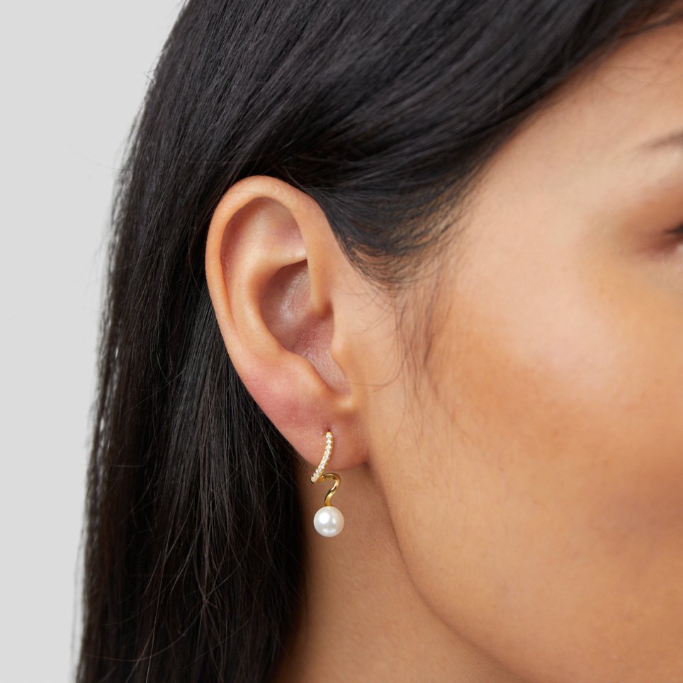 Tamara Pearl Wave Earrings, worn on an ear, gold hoop with pearls and a pearl drop