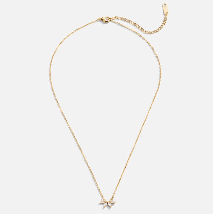 Tiffany Crystal Leaf Pendant Necklace, flat lay of a gold chain with a small crystal bow pendant