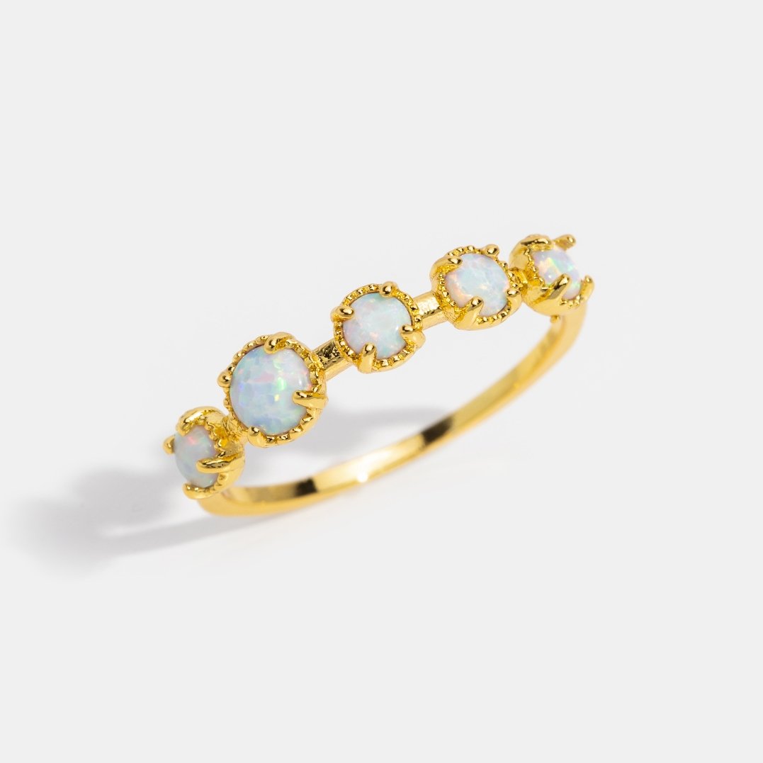 Tiffany Opal Stone Ring, gold ring with five graduated opal stones on a white background