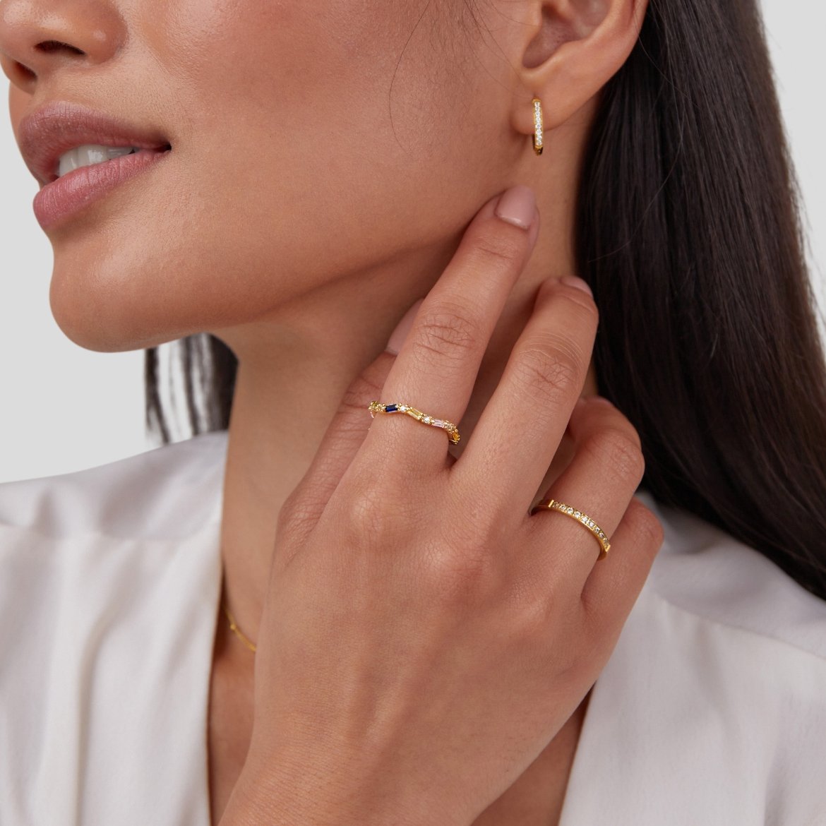 Timeless Beauty 18K Crystal Ring, worn on a hand with a gold hoop earring and second ring