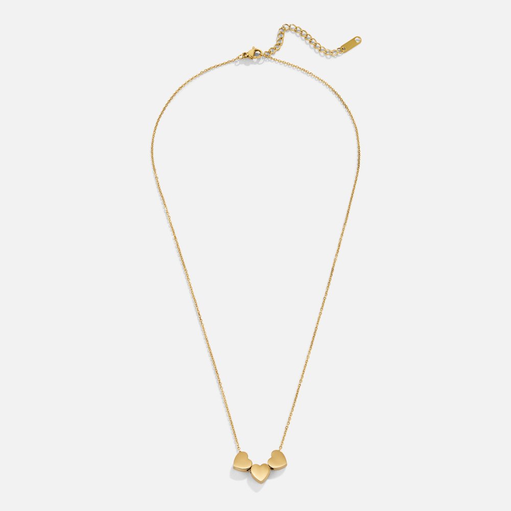 Trio Heart Pendant Necklace, flat lay of a gold chain with three small heart charms at the centre