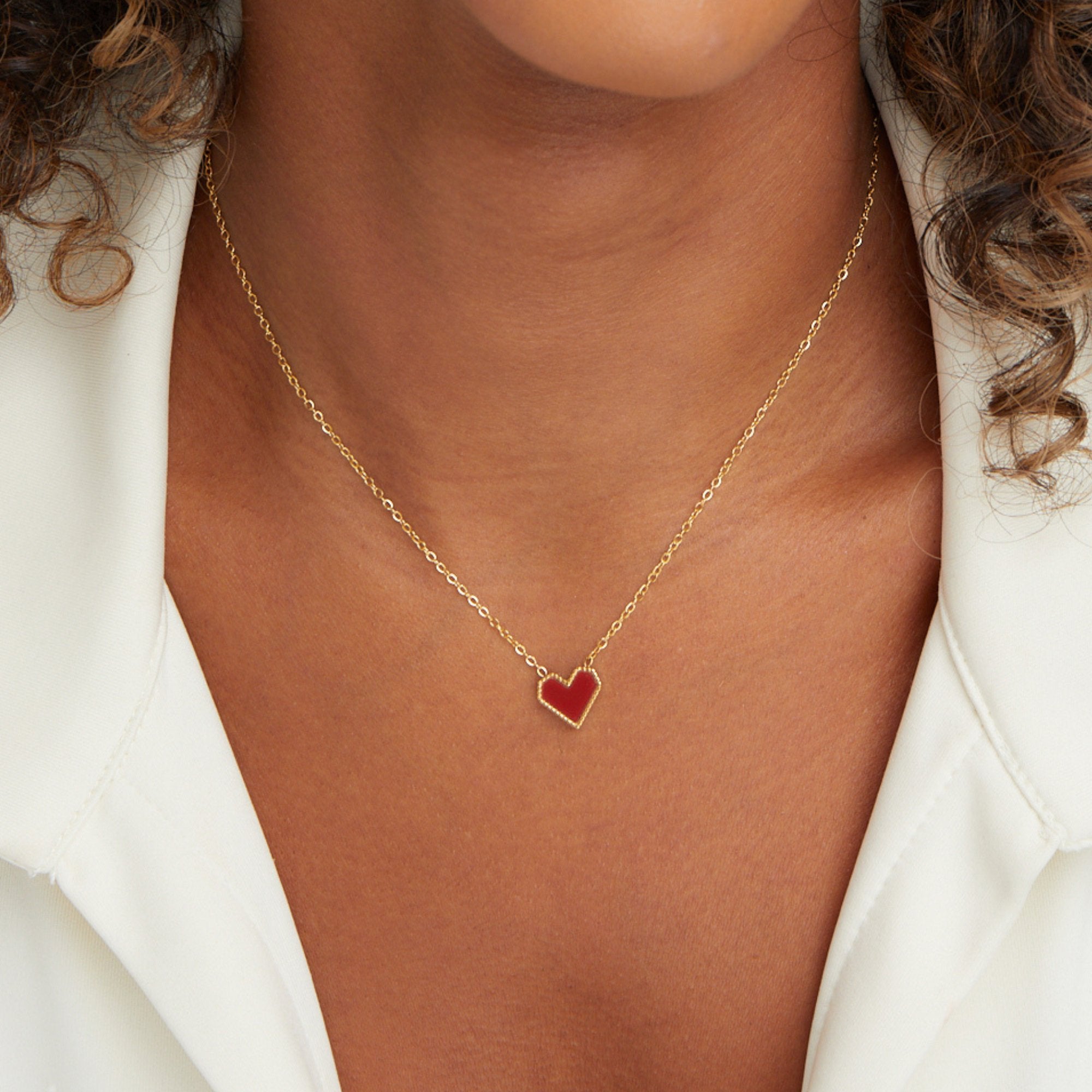 Valentina Heart Necklace, worn on a neck with a white open-collar shirt, red heart pendant