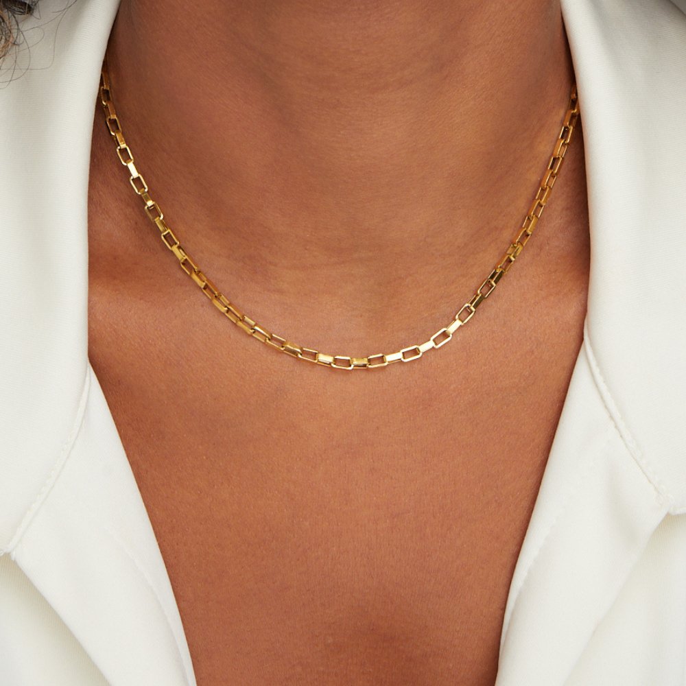 Venna Gold Chain Necklace, worn on a neck over a white collared shirt, close-up of gold links