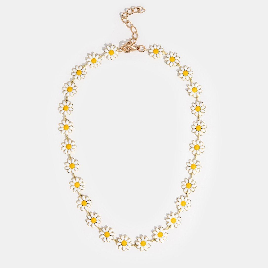 White Daisy Flower Necklace, laid flat on a pale background, daisies in a loop with a gold clasp